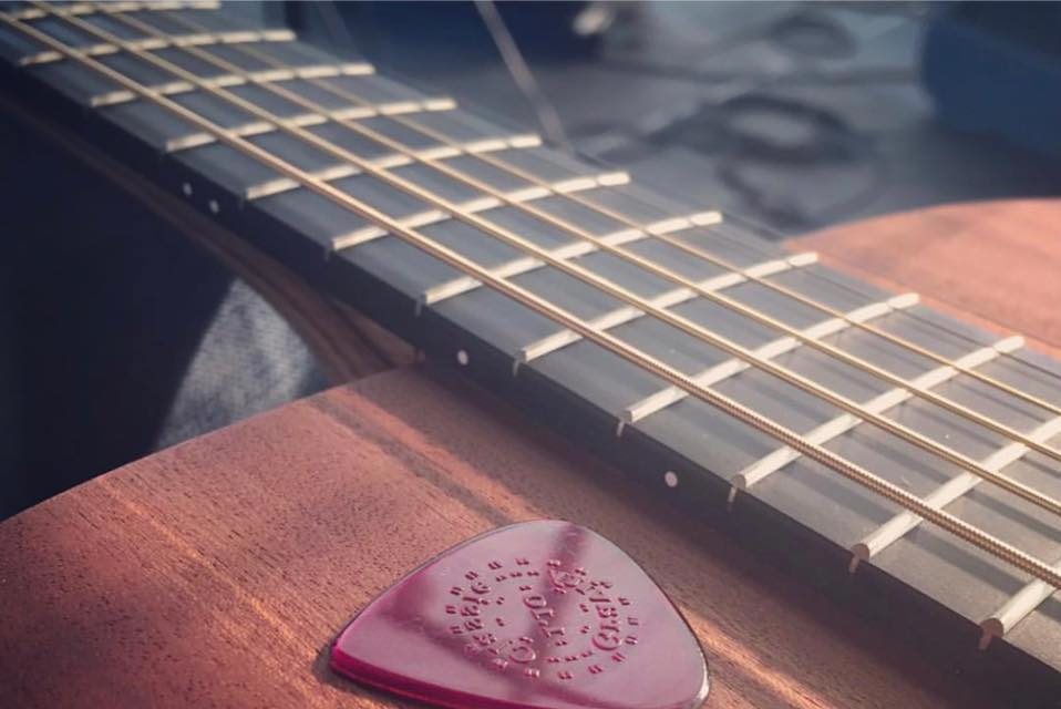 acoustic guitar and plectrum to be played at a wedding